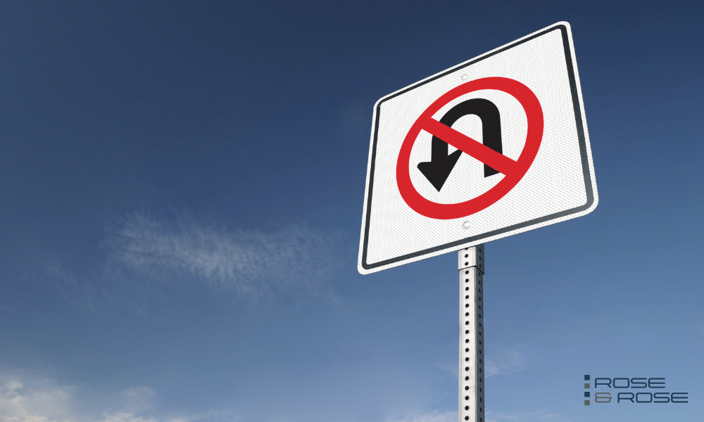 No U-turn road sign on blue sky